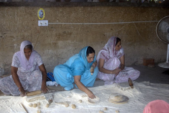 Señoras sij preparando roti en la cocina comunitaria del Templo Dorado en Amritsar - Imagen de Attila Jandi