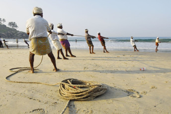 Pescadores tirando su cerco fuera del mar en la playa Kovalam, Kerala. La pesca sigue siendo la principal fuente de ingresos para los locales en todo Kerala - Imagen de Vlad Karavaev